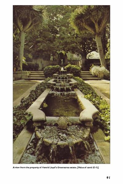 Cascading water flows through a lush garden framed by tall palms, evoking classic Hollywood glamour—just like the settings featured in "More Hollywood Homes" from Schiffer Publishing, Ltd.