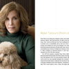 A woman with wavy light brown hair and a green turtleneck sits indoors, holding a small fluffy dog on her lap. Text about "Branding + Interior Design" by Schiffer Publishing, Ltd. appears on the right side of the image.
