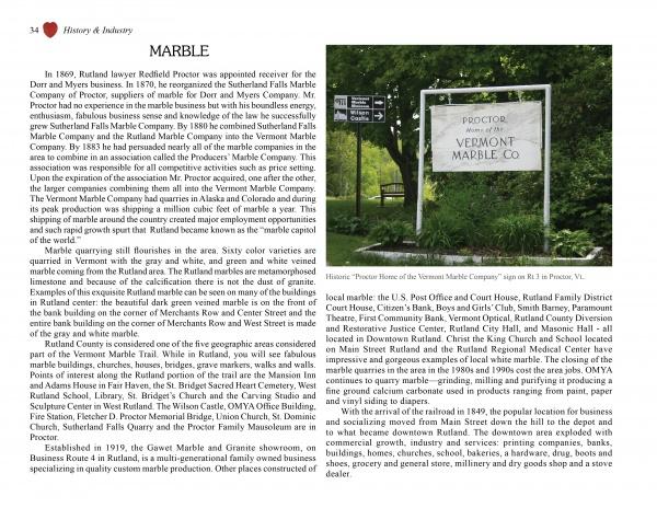 A historic marker stands on a grassy lawn near trees and a road, evoking scenes from "Greetings from Rutland, VT" by Schiffer Publishing, Ltd., with a building partially visible in the background.