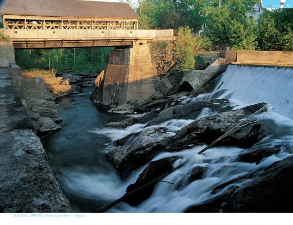 Timeless Crossings" by Schiffer Publishing, Ltd. features a covered wooden bridge over a rocky river and waterfall amid lush trees, with sunlight casting scenic shadows—an ideal capture for fans of rural Vermont and bridge photography.