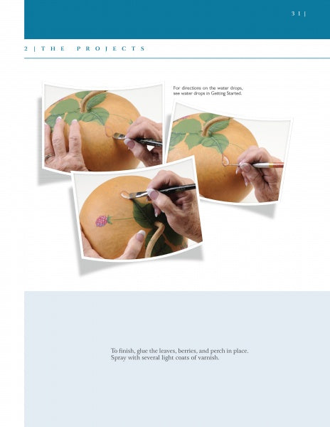 Three photos from "Building Gourd Birdhouses with the Fairy Gourdmother®" by Schiffer Publishing, Ltd. show hands painting leaves, water droplets, and a purple berry on a gourd. The white background provides step-by-step instructions.