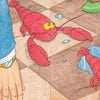 A playful scene from Schiffer Publishing, Ltd.'s "Lobsters on the Loose" shows lobsters scuttling across a brown checkered floor with puddles, dodging legs in green heels, white sneakers, and blue pants as rhyming text appears top left.