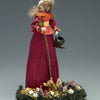 Discover Appalachian craft with "Making Colorful Corn Shuck Dolls" by Schiffer Publishing, Ltd.—a guide inspired by figurines like the woman in a red dress and bonnet, holding a watering can with "Joy of Gardening" on a base of artificial flowers.