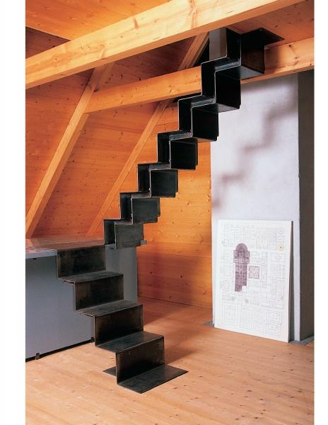The book "Stairways" by Schiffer Publishing, Ltd. features modern metal zigzag staircases leading to lofts with wood beams and floors, with large artworks accenting adjacent walls—ideal inspiration for standout architectural designs.