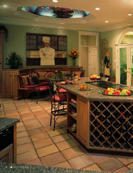Great Kitchens by Schiffer Publishing, Ltd. showcases a roomy custom kitchen with a large island featuring a wine rack, stools, tiled floors, chef mural, decorative plants, and French doors that brighten the space with natural light.