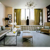 Modern living room inspired by Showhouses 2 from Schiffer Publishing, Ltd., featuring a beige sofa, two ottomans, glass coffee table, abstract painting, tall white vases, armchair, geometric chandelier, and green curtains.