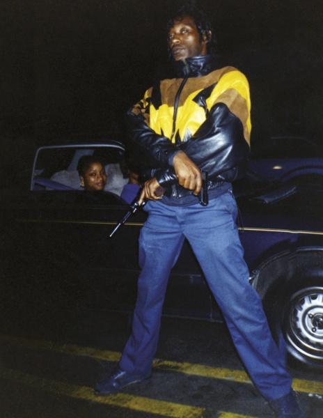 Greg Batman Davis by Schiffer Publishing, Ltd. features a confident figure in a leather and yellow jacket, gun in hand, with two women in a dark car behind him at night, capturing the aura of an Original Gangster.