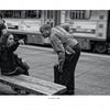 Captured in striking black and white, “Boston Below” by Schiffer Publishing, Ltd. reveals daily life on the MBTA: a woman sits on a bench, pointing assertively as a man leans in to listen, with city bustle in the background.