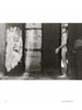She Shoots Men by Schiffer Publishing, Ltd.: A black and white photo captures an intimate nude male figure in a narrow doorway, framed by textured walls as window light casts dramatic shadows.