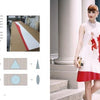A book spread from "Pleating" by Schiffer Publishing, Ltd. features fabric pleating diagrams and panels on the left, while on the right, a woman in a white dress with red accents and a lion motif stands outside a building.