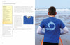 A boy on a sandy beach holds an orange surfboard, wearing a blue t-shirt with a white wave design. On the left, printmaking activity instructions from "Print It!" by Schiffer Publishing, Ltd. are visible.