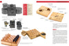 A magazine spread features “The Secret History of STASI Spy Cameras” by Schiffer Publishing, Ltd., showcasing vintage Cold War cameras, hidden chess sets, and wooden boxes used for espionage and concealment.