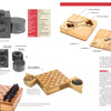 A magazine spread features “The Secret History of STASI Spy Cameras” by Schiffer Publishing, Ltd., showcasing vintage Cold War cameras, hidden chess sets, and wooden boxes used for espionage and concealment.