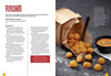 Crisp French Fries spill from an open brown paper bag onto a black surface with a fork and dipping sauce, featured with a Schiffer Publishing, Ltd. potato cookbook recipe and preparation instructions.
