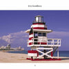 The "South Beach Lifeguard Stations" from Schiffer Publishing, Ltd. showcases a red and white striped lifeguard stand on a sandy beach, with a blue sky, ocean, and distant city buildings in the background.