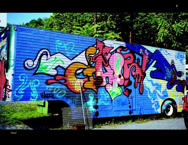 Truck Art by Schiffer Publishing, Ltd. showcases a blue-based trailer adorned with vibrant graffiti of bold shapes and letters in pink, orange, green, and blue, parked outdoors near trees and gravel.