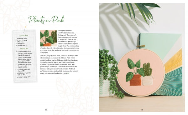 An open copy of Freshly Stitched by Schiffer Publishing, Ltd. displays a modern embroidery project with green plants in orange and white pots, alongside a succulent and geometric canvas art. The left page features text and patterns.