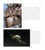 A magazine page with two images showcases "Robin Wood's CORES Recycled" by Schiffer Publishing, Ltd.: the top shows a vase with brushes, the bottom a wooden orb with glass rods, both with artist commentary and text descriptions.