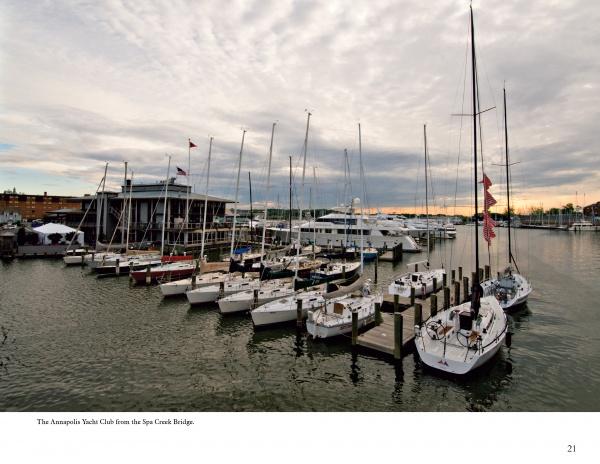 Annapolis Reflections by Schiffer Publishing, Ltd. captures sailboats docked at a marina in Annapolis, Maryland, with calm water and a modern yacht club at sunset—a tranquil harbor town scene with distant waterfront buildings.