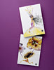 Celebrate contemporary stationery with "Today's Top Stationery Artists" by Schiffer Publishing, Ltd.—two illustrated postcards on purple, featuring a crowned woman in yellow and a girl flying with flower balloons, perfect for handwritten notes.
