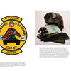 A display features a green jacket, 1st Platoon 3-64 Armor patch, helmet with goggles, documents, black combat boots, dog tag, group photo of soldiers, and M1 Abrams tank history from Schiffer Publishing, Ltd.