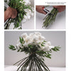 Three images from Schiffer Publishing, Ltd.'s "Creating Floral Centerpieces" show hands arranging and trimming white roses with green leaves, demonstrating bouquet tying techniques; the finished bouquet rests on a white surface.