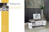 The "Vintage Cardboard Crafting" box by Schiffer Publishing, Ltd. sits on a white table beside a vase with a pink flower, a round mirror, and glass containers, against a dark gray wall. Text on the left reads Vintage Cardboard Crafting.
