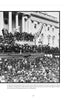 A large crowd gathers outside the U.S. Capitol for Lincoln’s second inauguration in 1865. Featured in "The Paranormal Presidency of Abraham Lincoln" by Schiffer Publishing, Ltd., he stands beneath an American flag among officials.