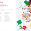 The Magic of Christmas to Cross Stitch by Schiffer Publishing, Ltd. is open to a festive pattern with Joyeux Noël, colorful threads, small gifts, and craft supplies on white. The left page is titled Christmas Morning—ideal for holiday cross-stitch ideas.