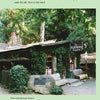 In front of a rustic wooden building labeled The Cold Springs Tavern, trees and greenery evoke haunted California legends. Discover more in "Spiritland: Ghosts of California's Central Coast" by Schiffer Publishing, Ltd.
