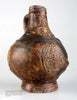 Early German Stoneware by Schiffer Publishing, Ltd.: a brown antique jug with a rounded body, single handle, and face medallion. It features a textured, uneven glaze characteristic of medieval ceramics for a rustic, aged look.