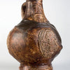Early German Stoneware by Schiffer Publishing, Ltd.: a brown antique jug with a rounded body, single handle, and face medallion. It features a textured, uneven glaze characteristic of medieval ceramics for a rustic, aged look.
