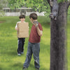 Two boys stand on grass near a tree in front of a house. One holds a box, smiling, while the other holds a rock and looks at a baby squirrel on the trunk—an ideal scene from "Squirrel Rescue" by Schiffer Publishing, Ltd., perfect for wildlife rescue stories.