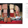 A large display of red and white quilts hangs in a spacious exhibition hall at the International Quilt Festival, featured in Magic & Memories by Schiffer Publishing, Ltd.; a contents page with section titles is shown on the right.