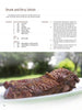 A cooked sirloin steak sits on a white plate outdoors. Above, a recipe from "The Big Smoker Book" by Schiffer Publishing, Ltd. features barbecue recipes, ingredients, low and slow prep steps, and a serving suggestion.