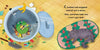 In Schiffer Publishing, Ltd.’s "C Jumped over Three Pots and a Pan and Landed Smack in the Garbage Can!", a green frog stuck in a food-filled trash can calls for help while a gray cat naps nearby—an imaginative ABC adventure with text on the image.