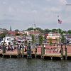 Annapolis Reflections" by Schiffer Publishing, Ltd. captures a waterfront scene at Annapolis City Dock, with people on the brick promenade, boats, an American flag, historic buildings, and the Maryland State House dome in the background.