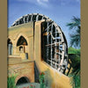A large wooden water wheel is fixed to an old stone building with arches in a lush landscape under a blue sky—an image reminiscent of the mystical designs in Schiffer Publishing, Ltd.'s Tarot of the Moors deck. The text below says The Water Wheel.