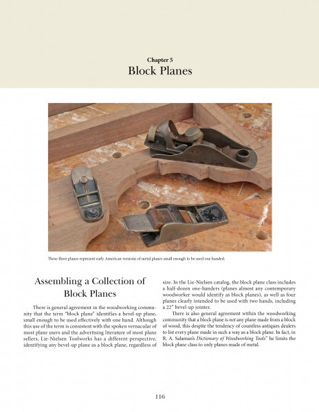 Three wooden hand planes and one metal block plane sit on a workbench above an open copy of "Hand Planes in the Modern Shop" by Schiffer Publishing, Ltd.; the wooden planes differ in size and style.