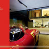 A red vintage Ferrari sits in an innovative garage with views of a stylish home interior. The left side shows a red overlay: HOME & AUTO 40 INTERNATIONAL PROJECTS. Auto-tecture by Schiffer Publishing, Ltd.