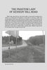 Black-and-white photo of a rural road with fields, trees, and blank traffic signs accompanies "Ghosts of Northern Illinois" by Schiffer Publishing, Ltd.—a tale featuring the Phantom Lady of Kennedy Hill Road.