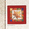 A quilted wall hanging from "Quilts of Chestnut Ridge" by Schiffer Publishing, Ltd. features an autumn leaf pattern in warm tones with a floral border and red edge, displayed on a light background. Text: Autumn Leaf wall hanging, 15 x 15.