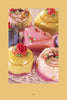 Enjoy an array of colorful, heart-shaped and round petit fours with icing roses and swirls, beautifully displayed— the perfect treats to accompany your next session with The Tarot Playbook.