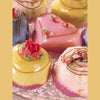 Enjoy an array of colorful, heart-shaped and round petit fours with icing roses and swirls, beautifully displayed— the perfect treats to accompany your next session with The Tarot Playbook.
