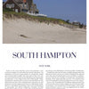 The Suburban Classic by Schiffer Publishing, Ltd. features a spacious shingle-style home atop a grassy dune with stunning views of a sandy beach in Southampton, New York, beneath a blue sky dotted with wispy clouds.