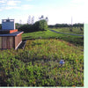 Schiffer Publishing, Ltd.’s ‘Award-winning Green Roof Designs’ features modern buildings topped with lush wildflowers and grass, highlighting living architecture set in grassy landscapes beneath clear skies.