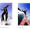 Two surfers glide on waves under a clear sky—one in a wetsuit, the other barefoot on a red board—splashing water surrounds them. From Schiffer Publishing, Ltd.: “Flying Through the Clouds,” inspired by Jim Russi's iconic surf photography.