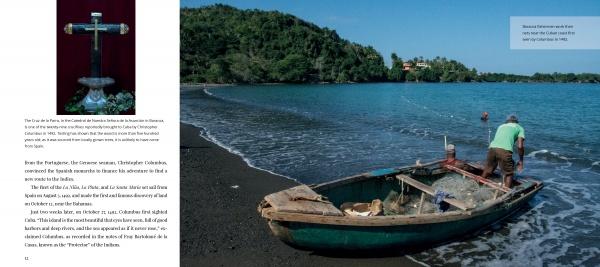 A man stands by a debris-filled wooden boat on a dark sandy beach, symbolizing contemporary Cuba, as green hills and buildings loom behind. An inset cross appears on the left. Product: Cuba's Evolution by Schiffer Publishing, Ltd.