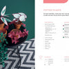 Three small clay pots with colorful paper plants from Paper Joy for Every Room by Schiffer Publishing, Ltd. sit on a round black table over a zigzag rug. A green wall adds charm; instructions and materials are listed on the right.