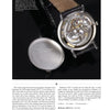 A close-up of an open Patek Philippe watch by Schiffer Publishing, Ltd., its back cover removed to reveal intricate mechanical movement. The metal cover rests nearby on a dark surface—ideal for watch investment enthusiasts.